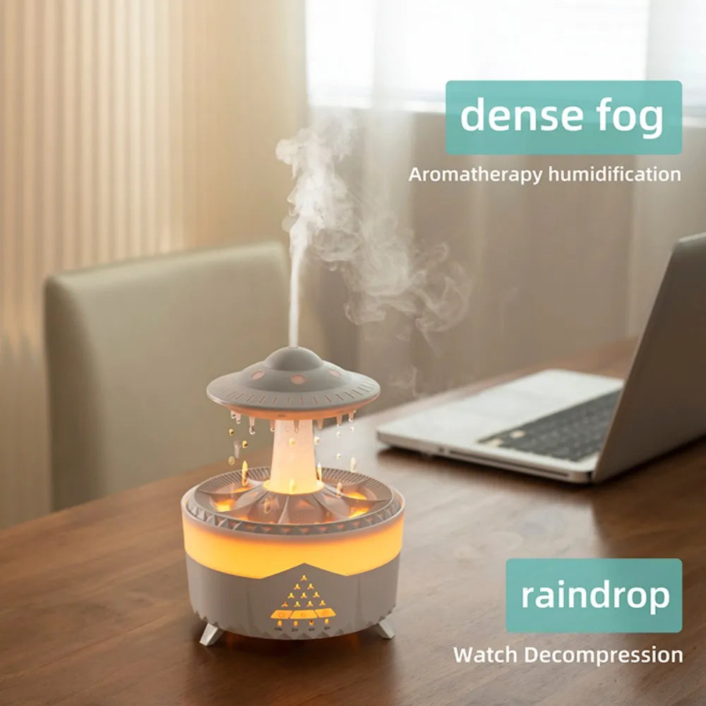 Rotating water droplet essential oil humidifier with dense fog and warm light on wooden desk
