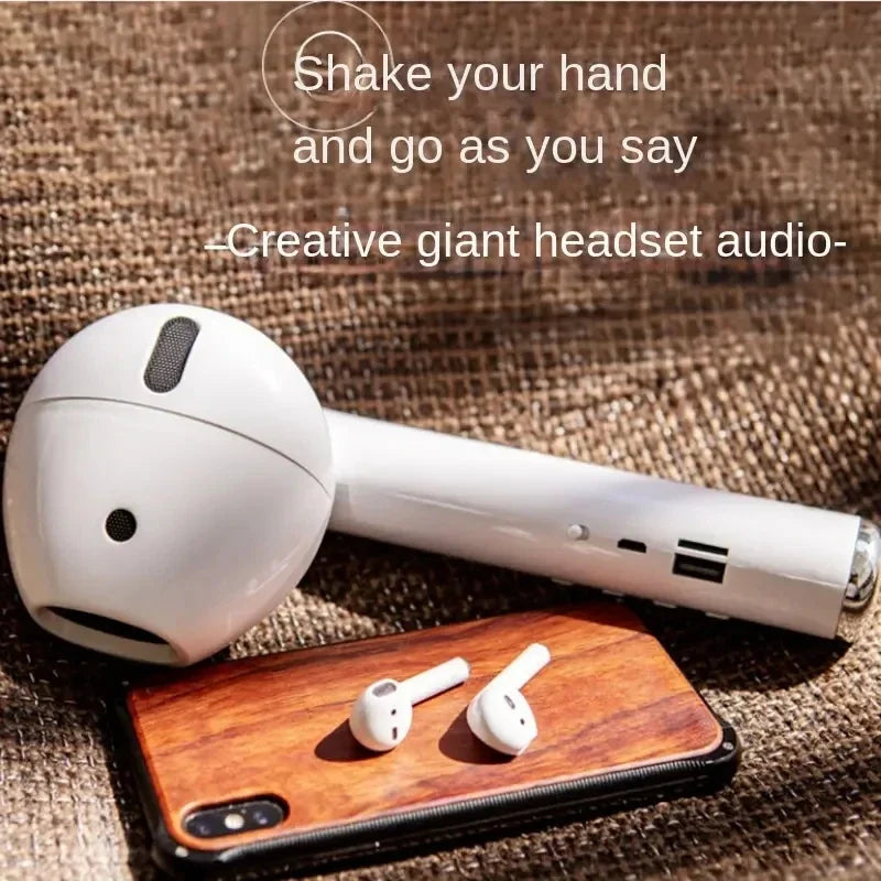 Wacky Bluetooth speaker unique design resembling a giant white earbud with a pair of small earbuds on a phone
